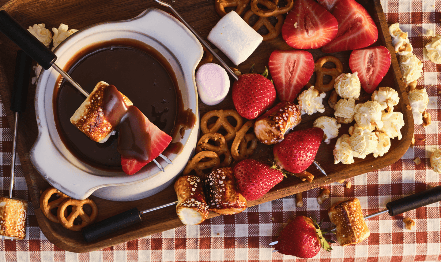 chocolate fondue with strawberries and marshmallows, romantic setting