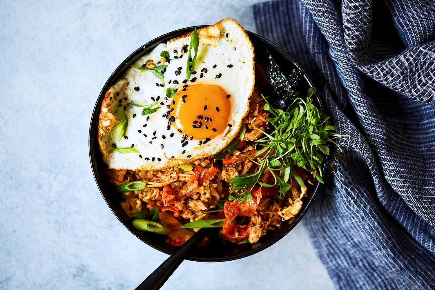 kimchi cauliflower rice stir-fry in a wok