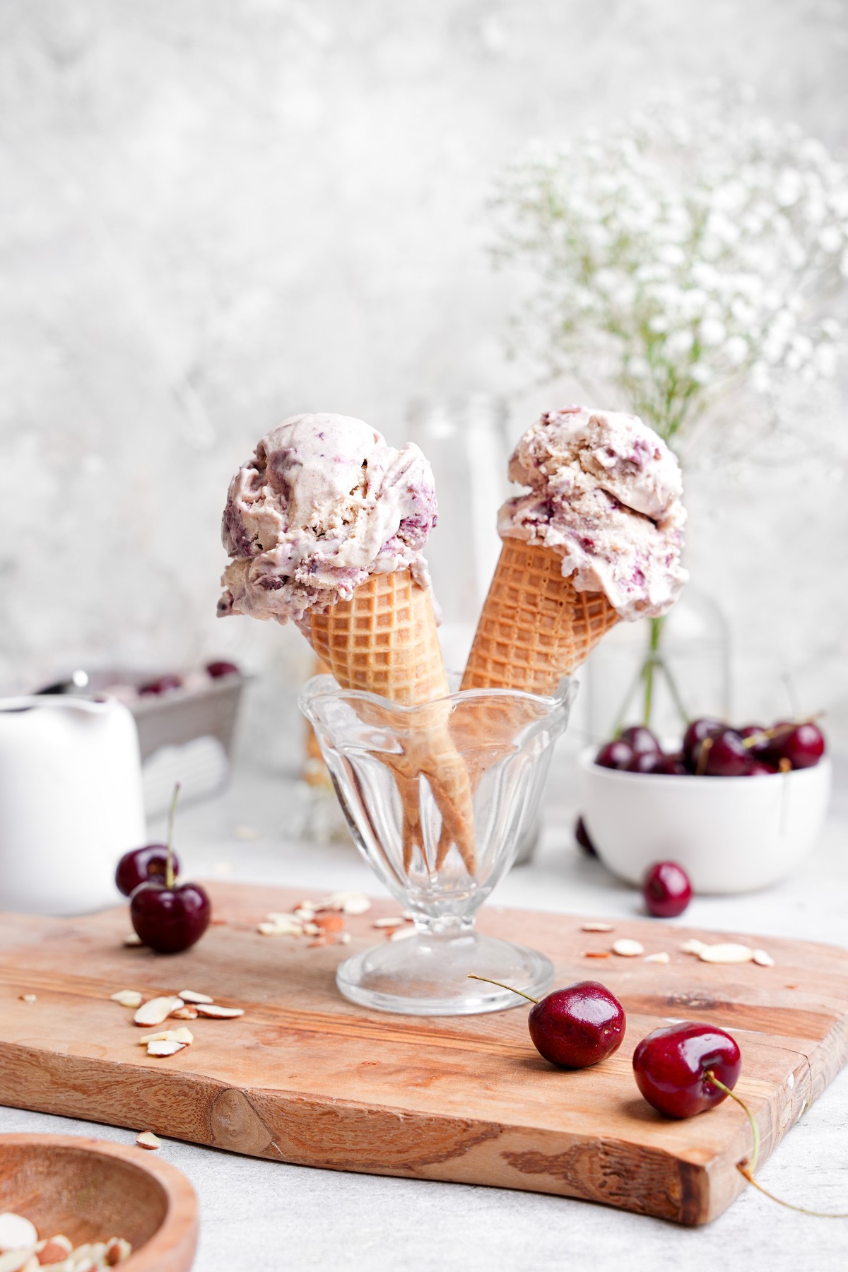 dairy-free cherry almond ice cream in a bowl with cherries and almonds