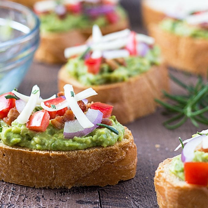 avocado toast with rosemary and garlic on a wooden board