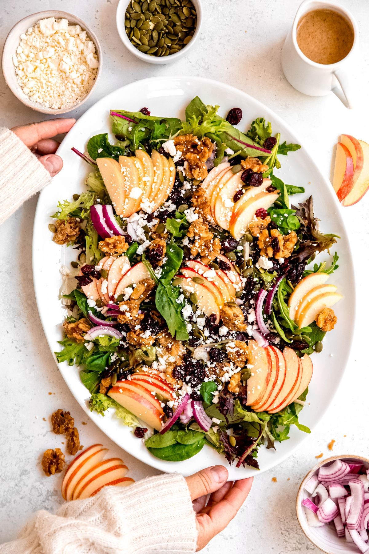 Vibrant apple walnut salad with honey drizzle in a wooden bowl, bright lighting