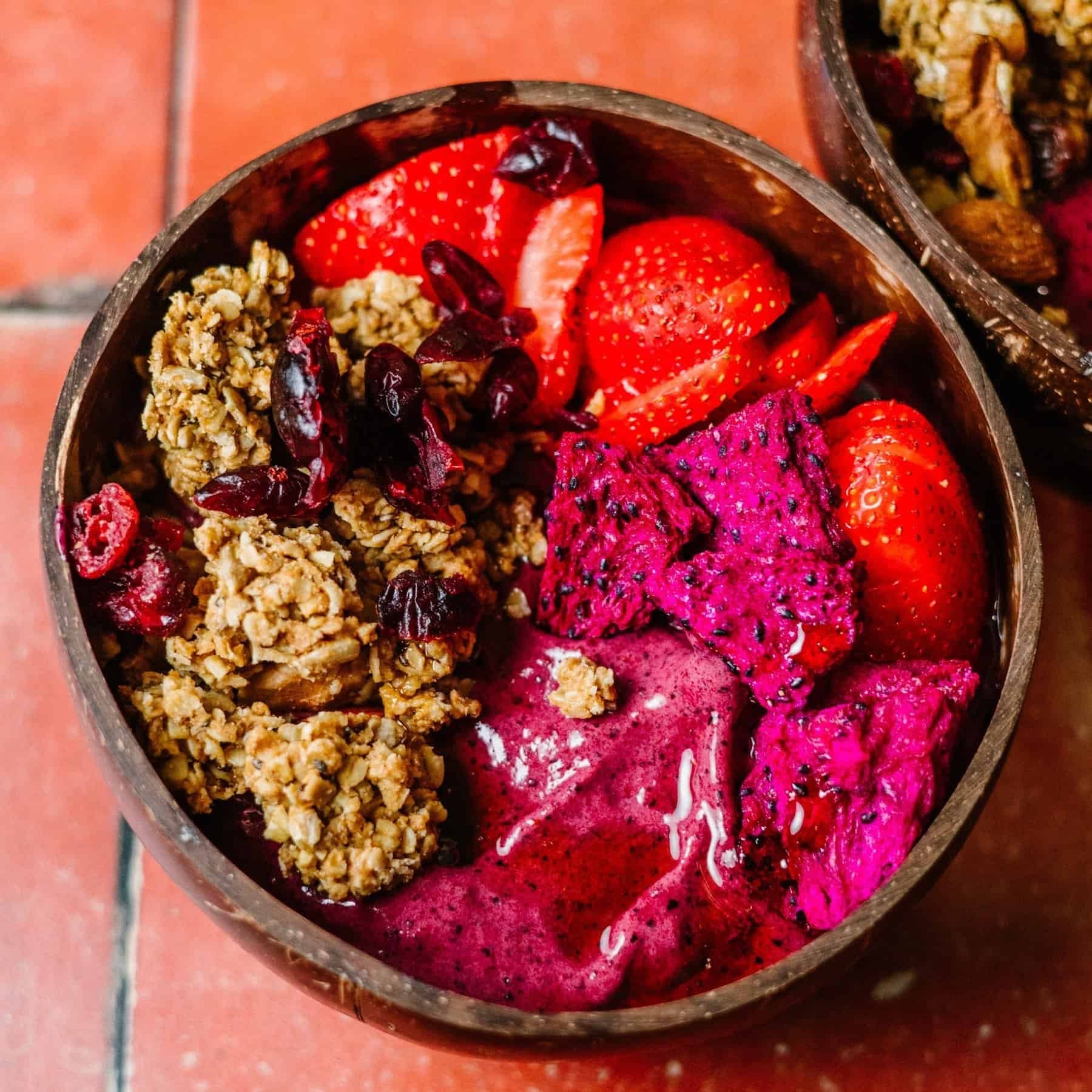 A vibrant blueberry pie smoothie bowl with various toppings like granola and fresh berries