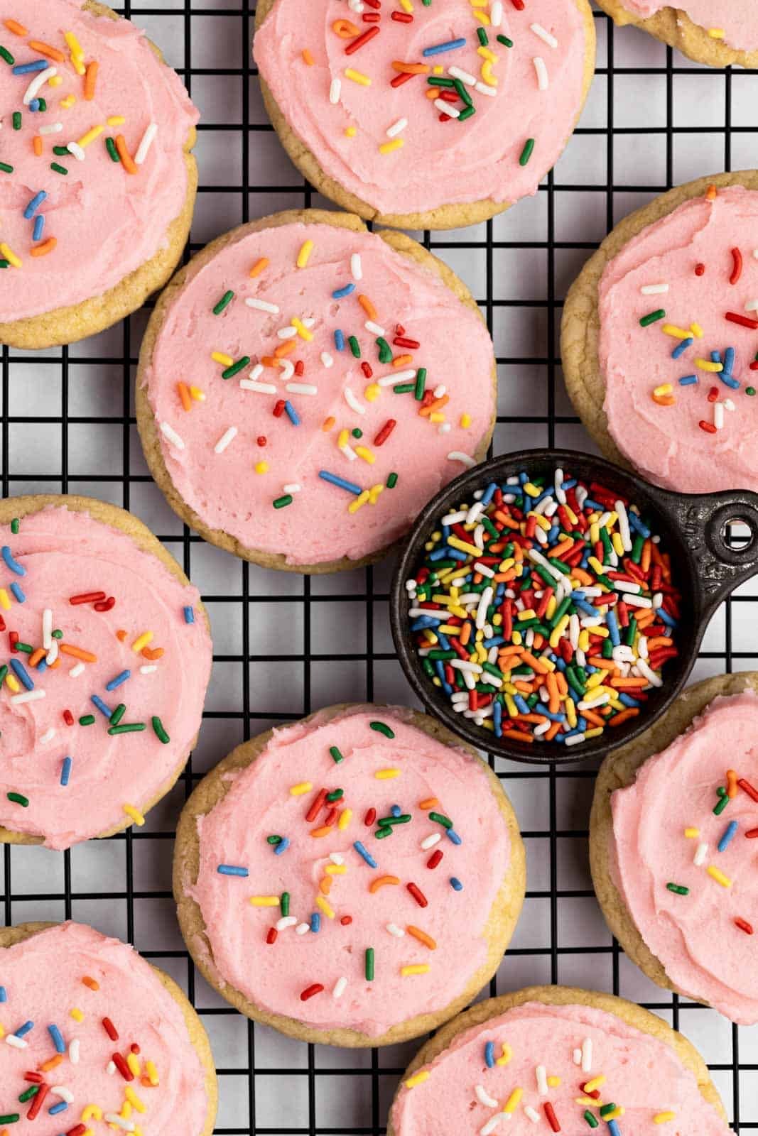 soft-baked sugar cookies on cooling rack, with a sprinkle of sugar on top, warm light