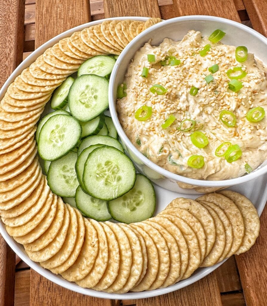 bowl of asian inspired dip with sesame crackers