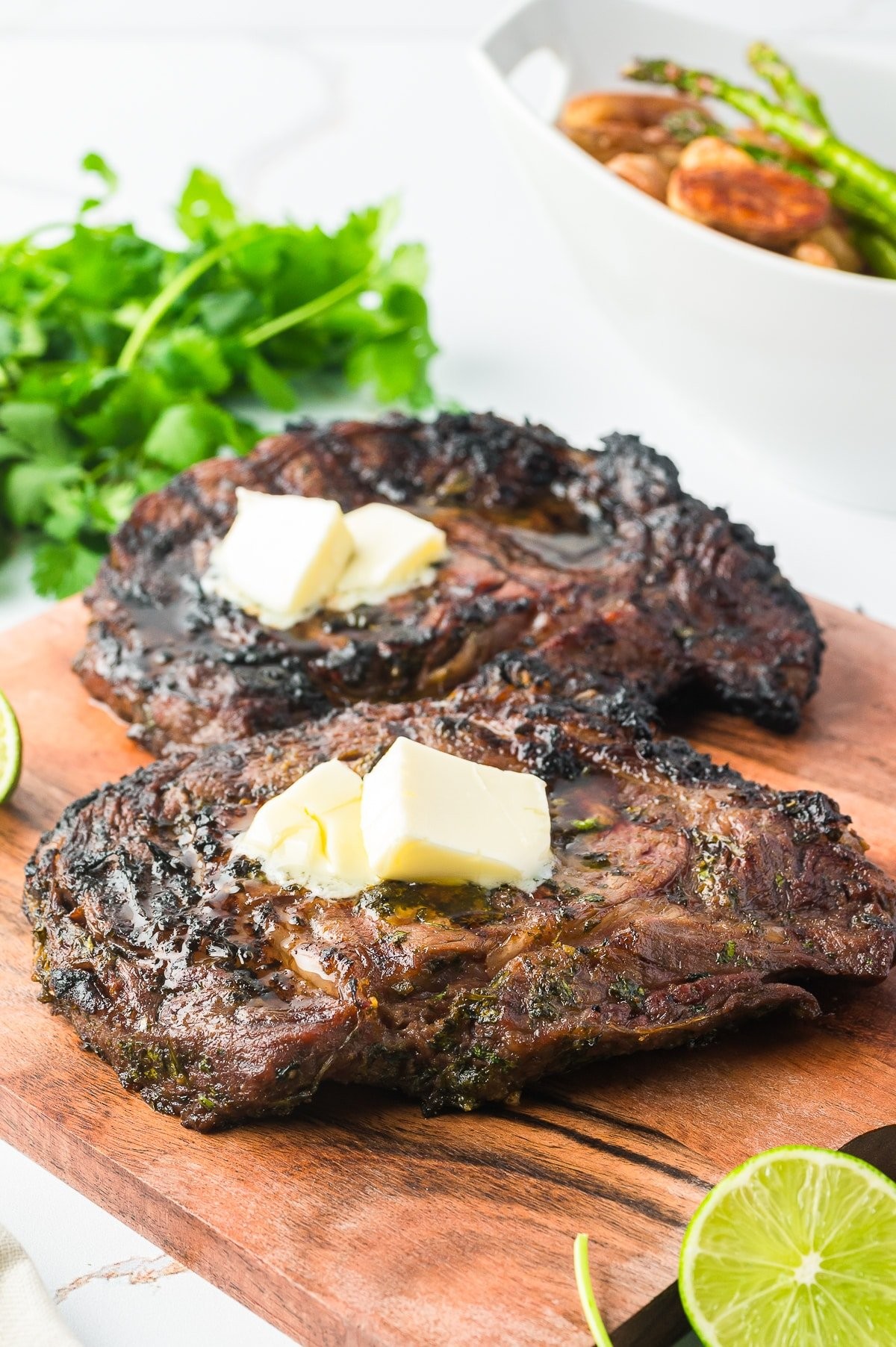 grilled skirt steak with cilantro-lime dressing being drizzled on top