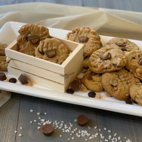 peanut butter sea salt chunk cookies on a rustic wooden board