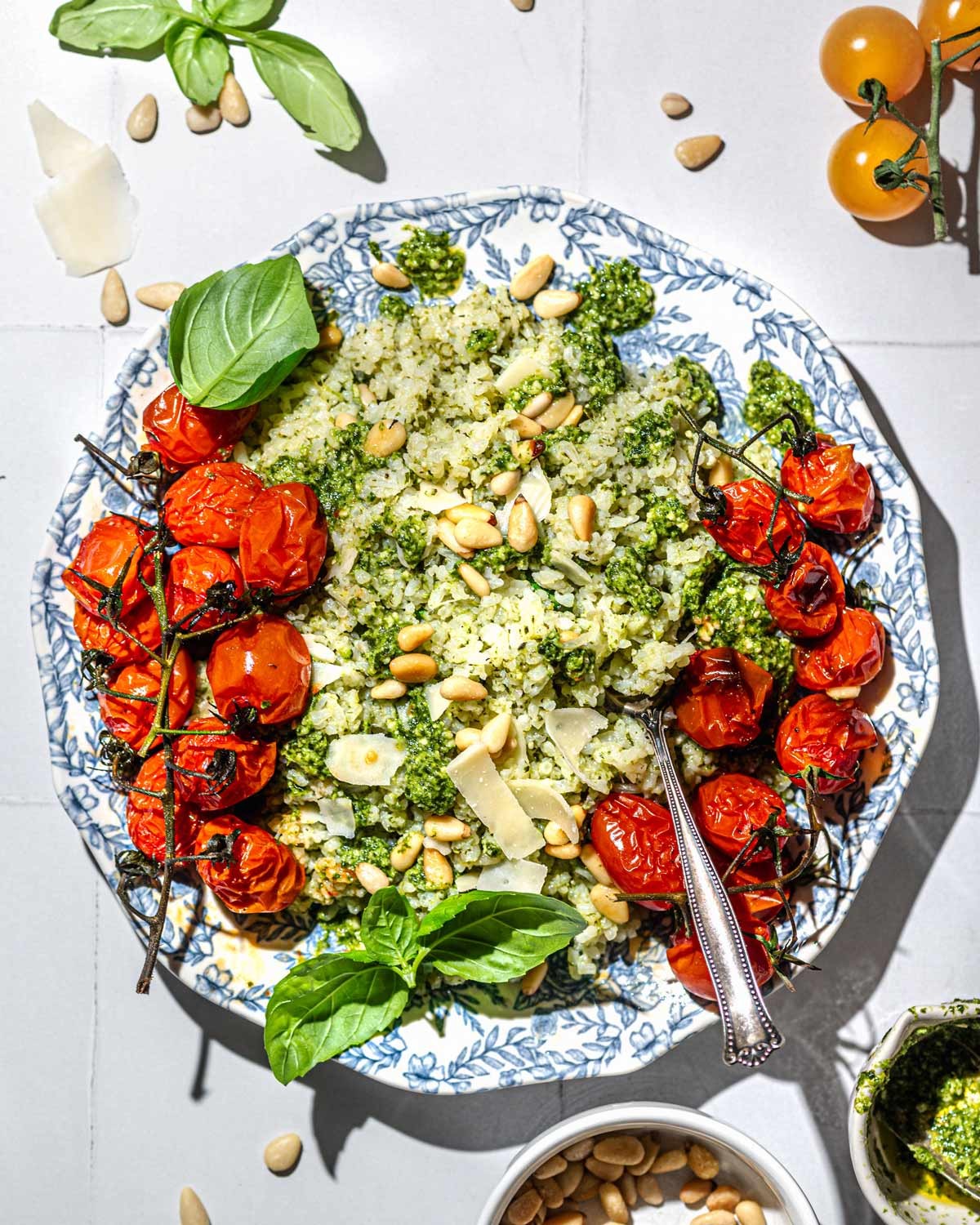 a vibrant bowl of kale pesto rice topped with toasted pine nuts