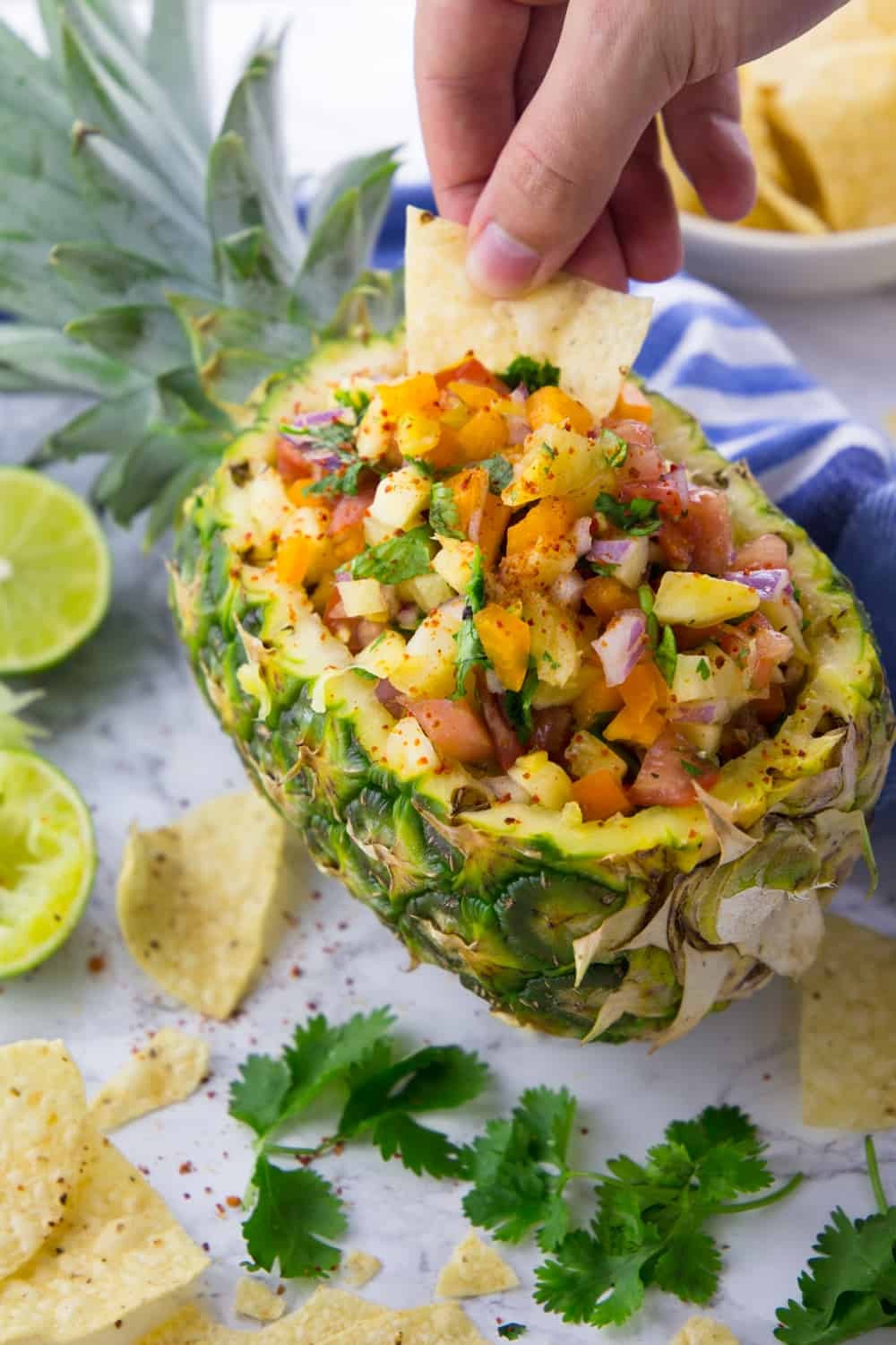 A vibrant, colorful bowl of Plantain and Pineapple Salsa Fresca, garnished with cilantro and lime