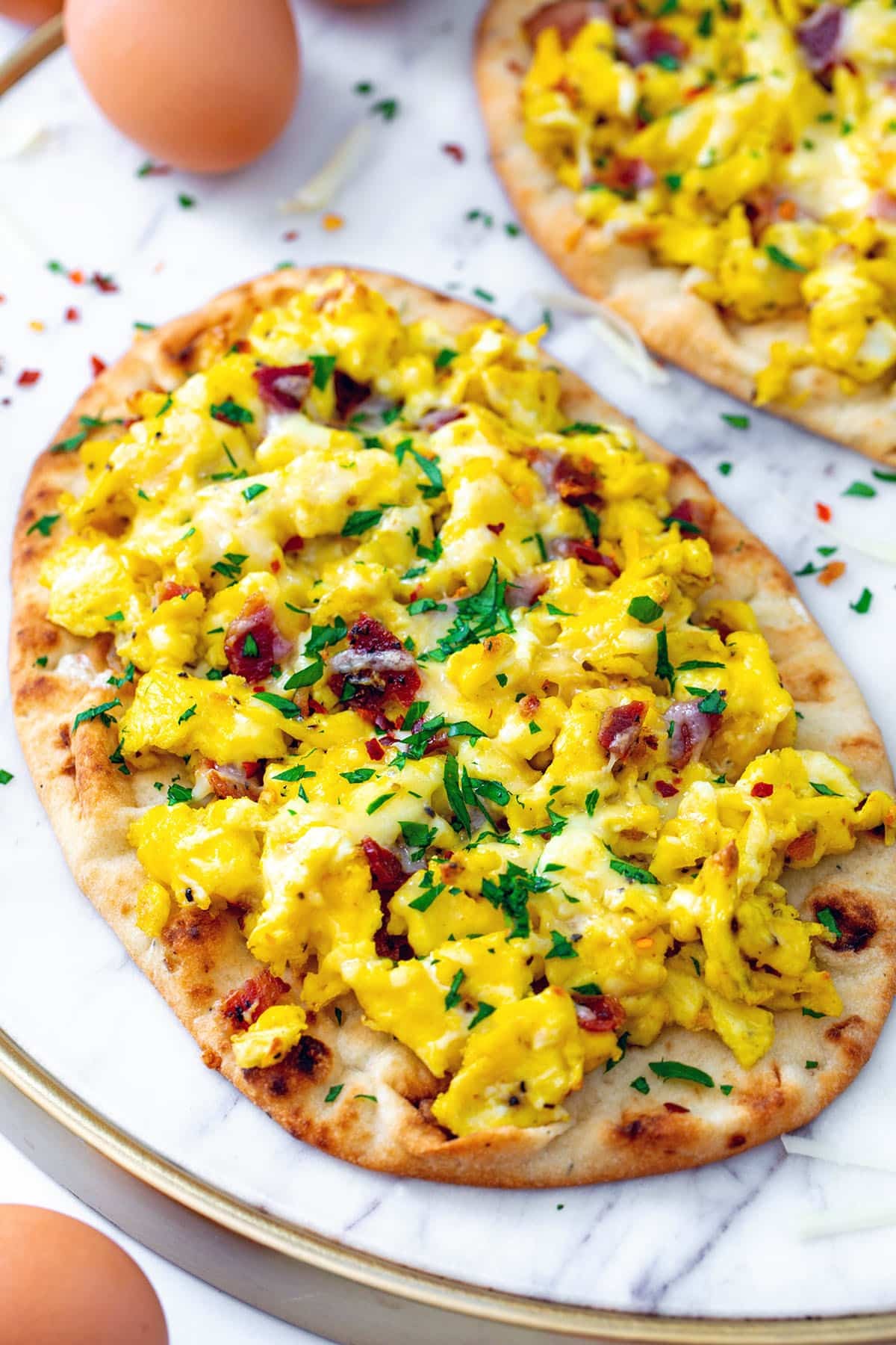 Breakfast pizza pancakes with scrambled eggs on a plate