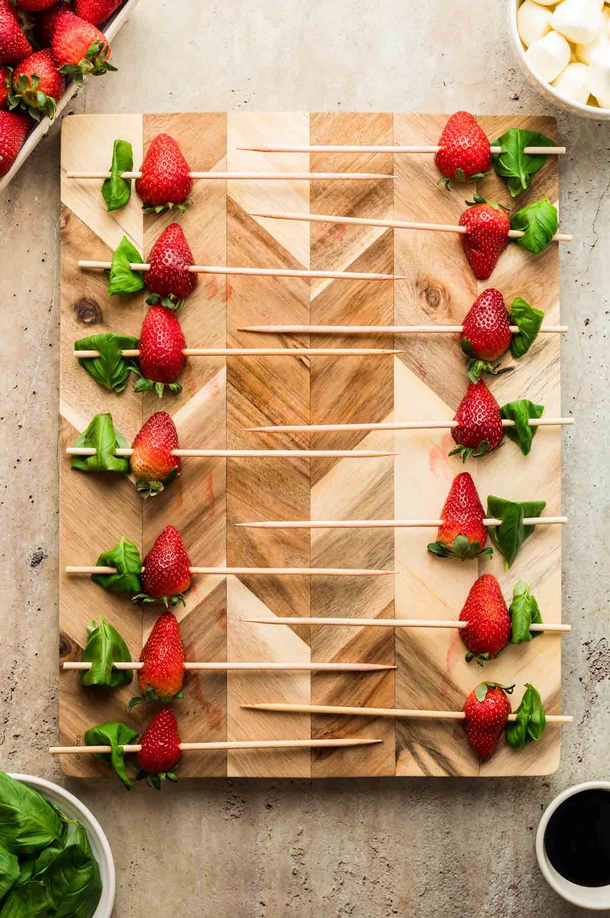 bright and colorful strawberry antipasto salad on a wooden board