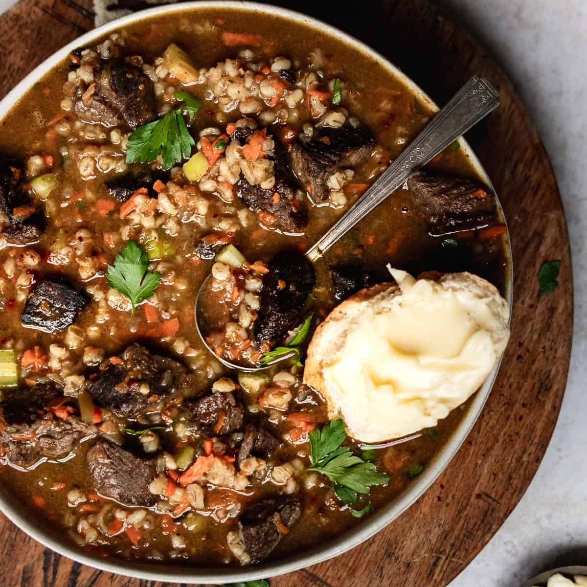 hearty beef and barley soup casserole in a rustic setting