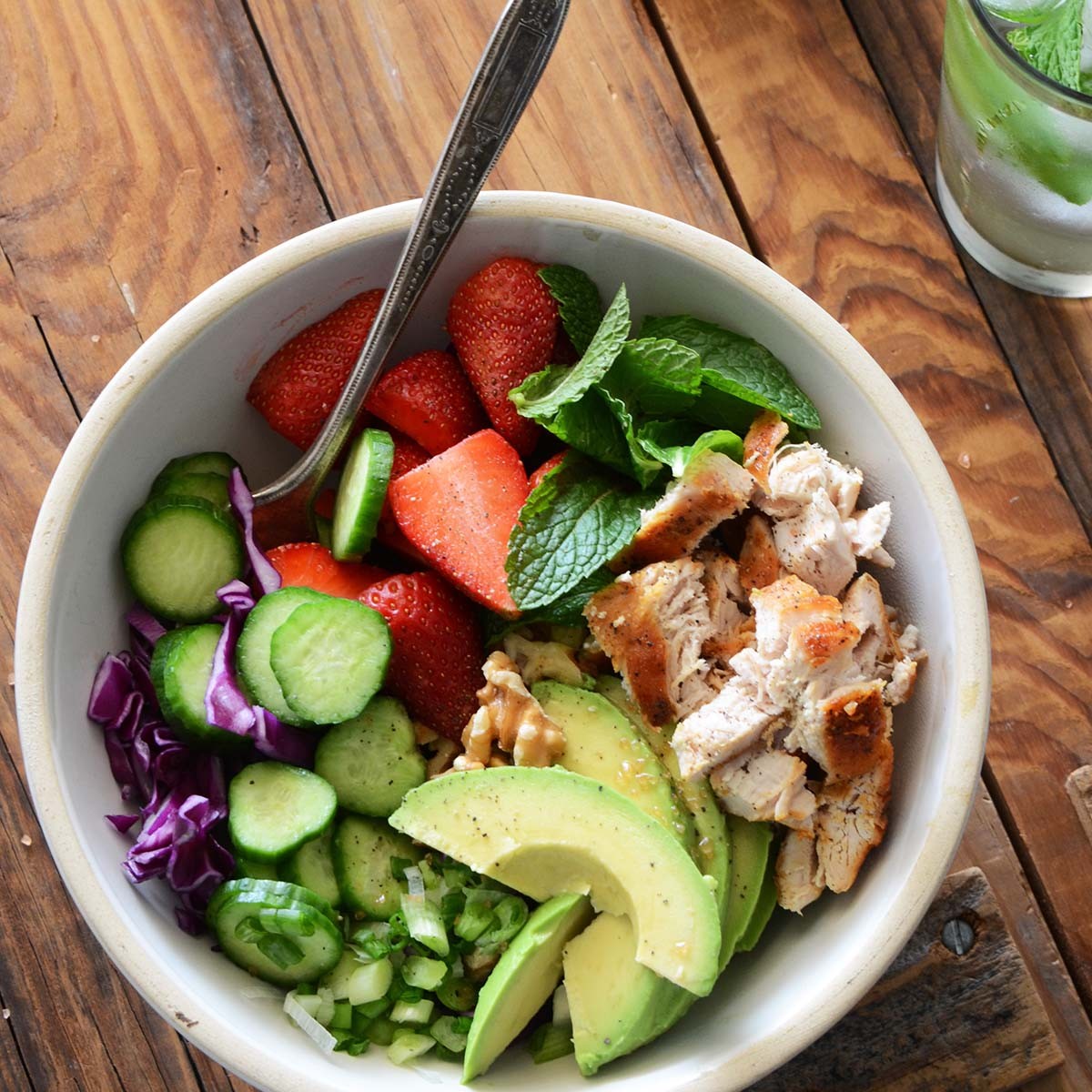 bright and colorful paleo bowl with chicken, vegetables, and avocado