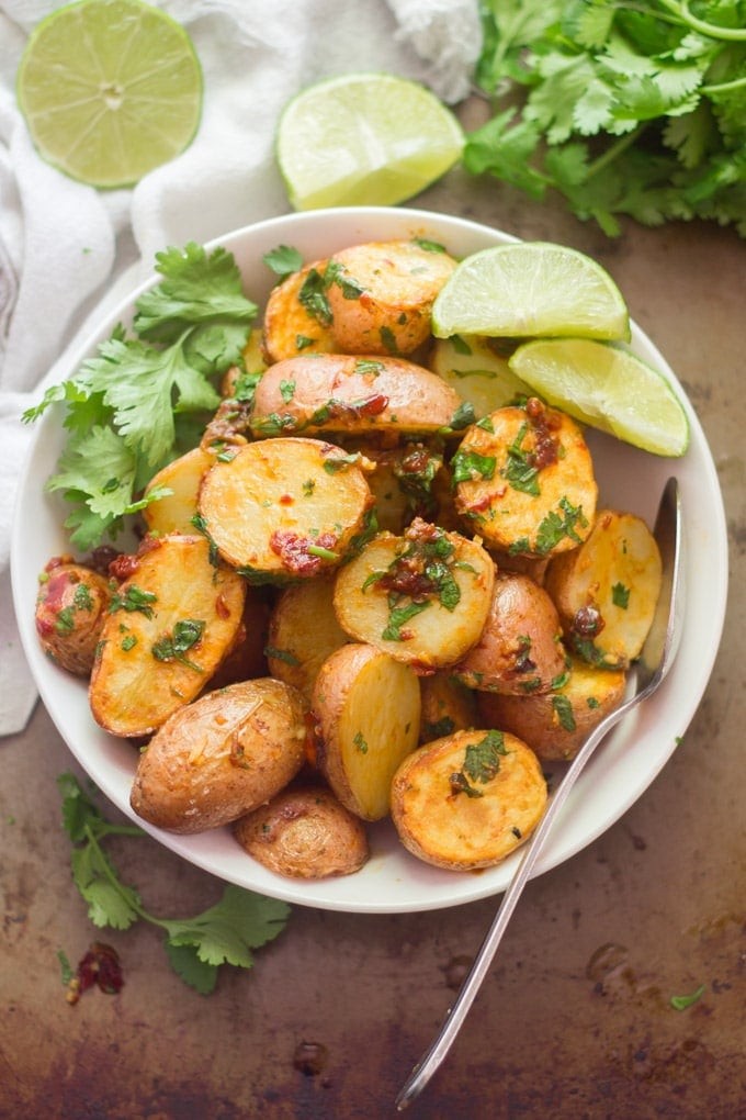 Close-up shot of spicy roasted potatoes with chipotle peppers, garnished with fresh cilantro