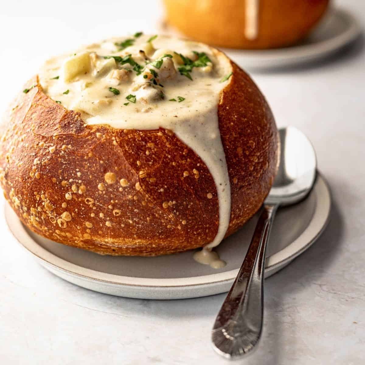 clam chowder served in a toasted bagel bowl