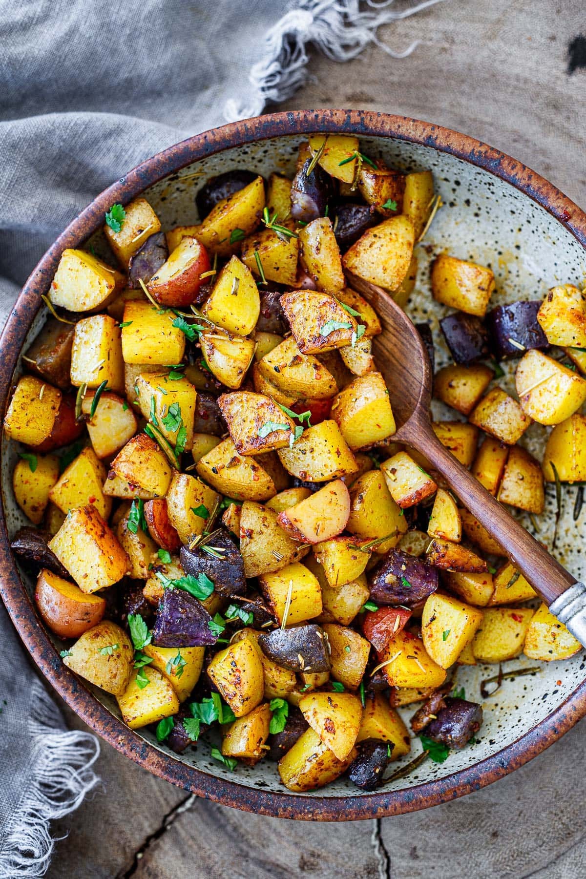 vibrant golden roasted herb breakfast potatoes with fresh rosemary and thyme