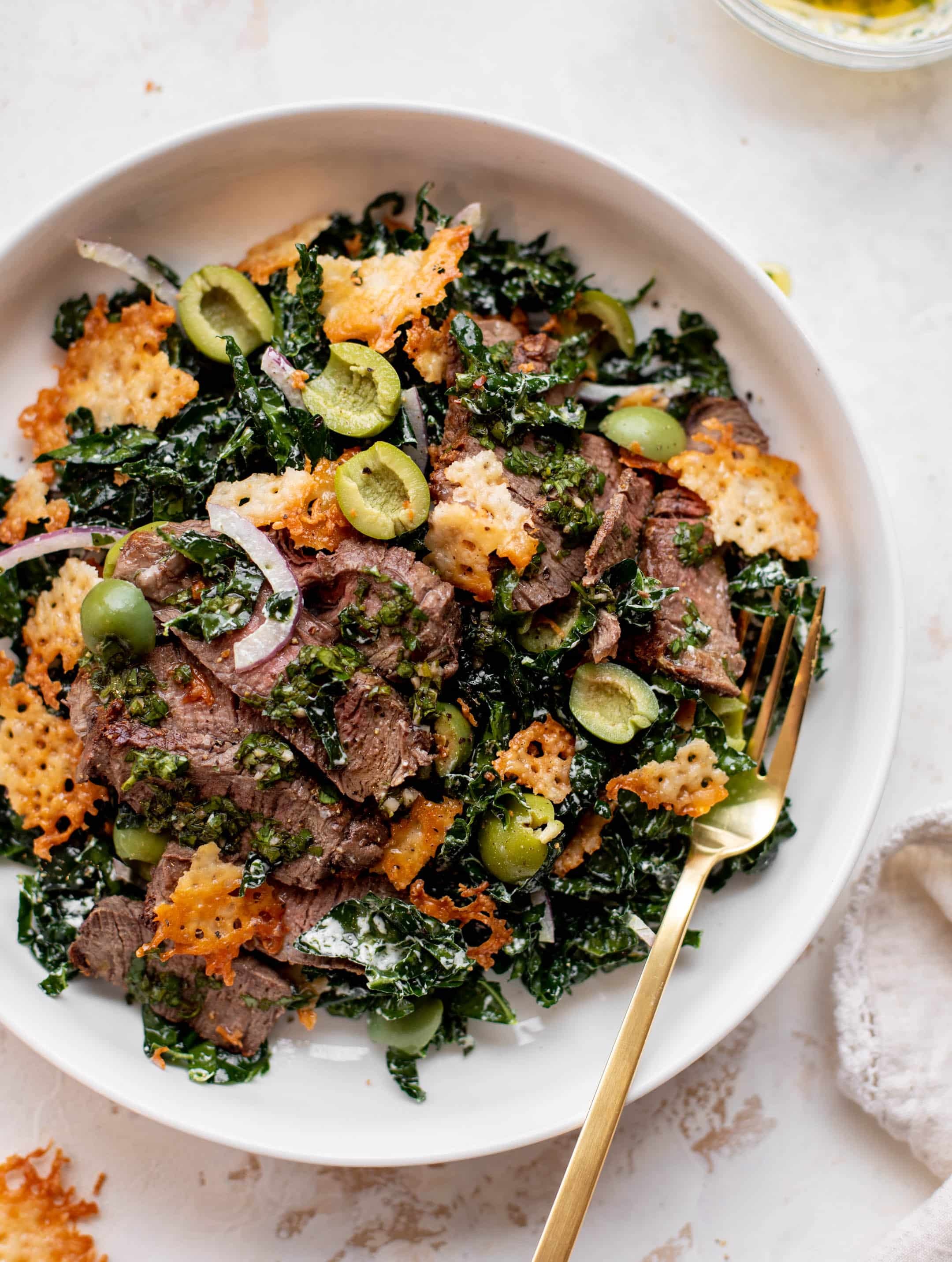 Juicy steak and vibrant kale salad in a rustic bowl