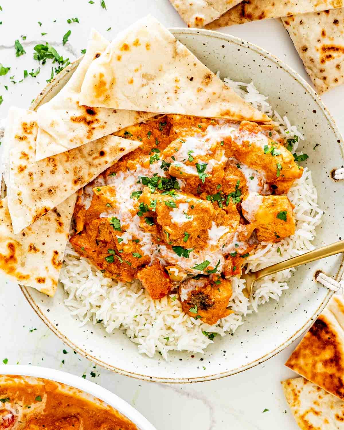Close-up shot of a flavorful Instant Pot Tikka Masala Stew with chicken and rice, garnished with cilantro