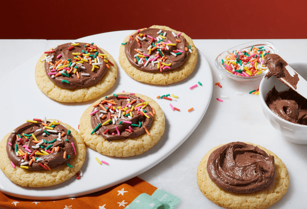 vibrant platter of holiday chocolate cookies with colorful royal icing and sprinkles