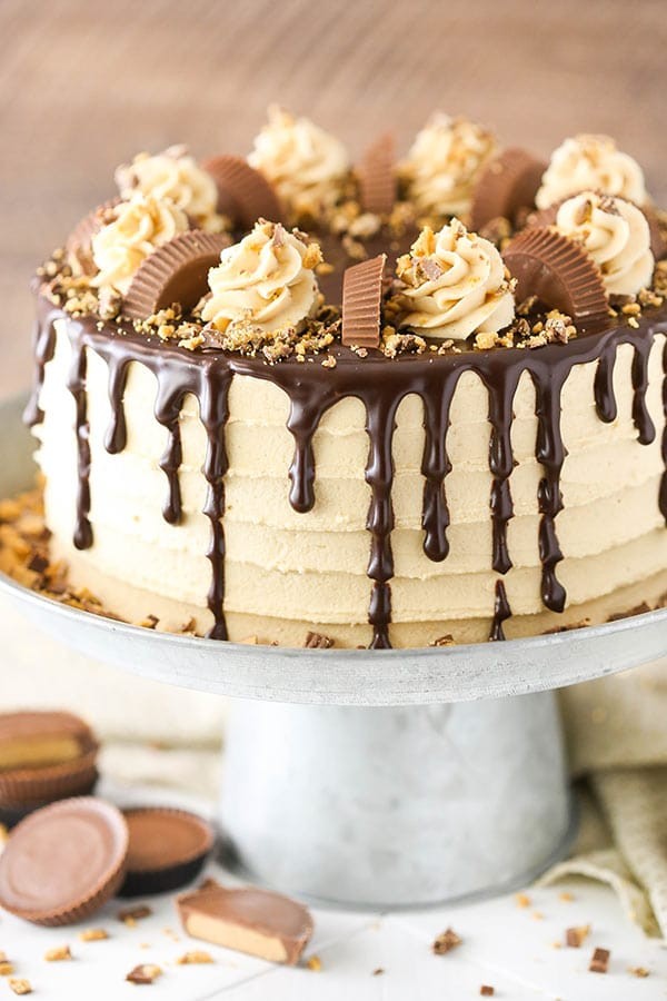 A decadent peanut butter cup birthday cake, frosted and decorated with peanut butter cups