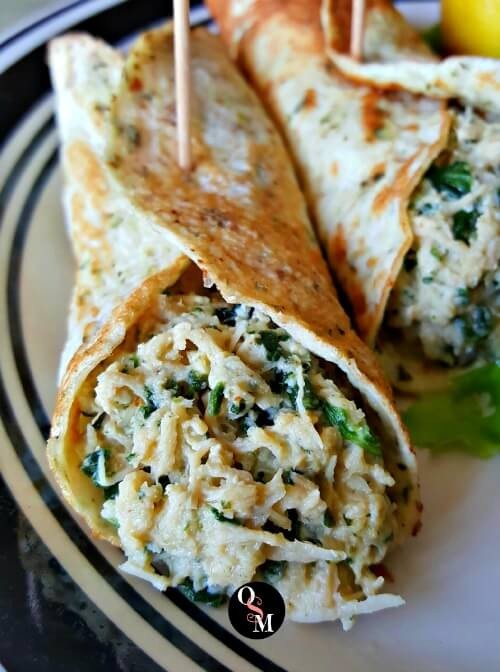 Close-up shot of Chicken Florentine Wraps with creamy sauce and spinach overflowing