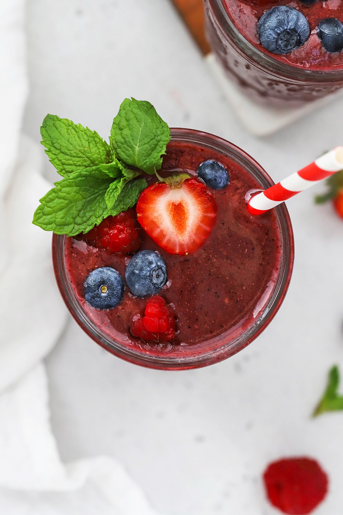 vibrant green smoothie with mixed berries and fresh mint