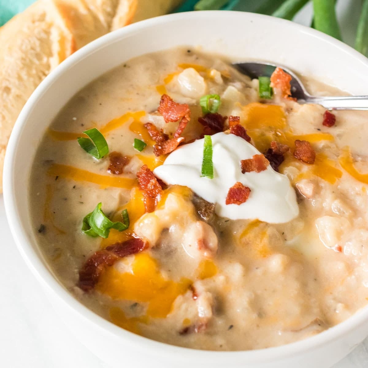 hearty smoked potato soup in a rustic bowl with crusty bread, steam rising