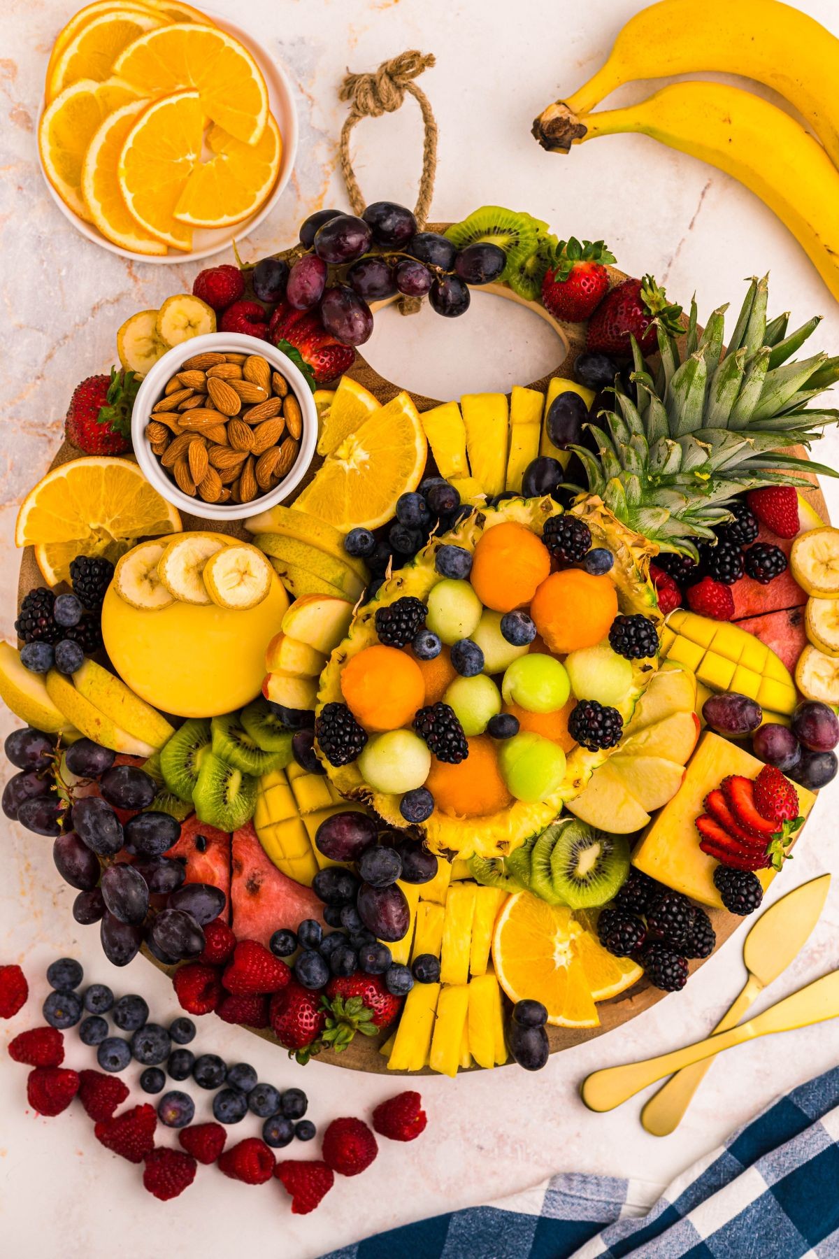 assorted banana bites and berry stacks on a wooden platter
