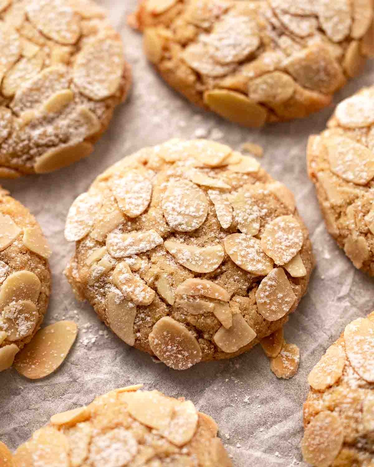golden brown almond cookies with crisp edges, close up, warm light