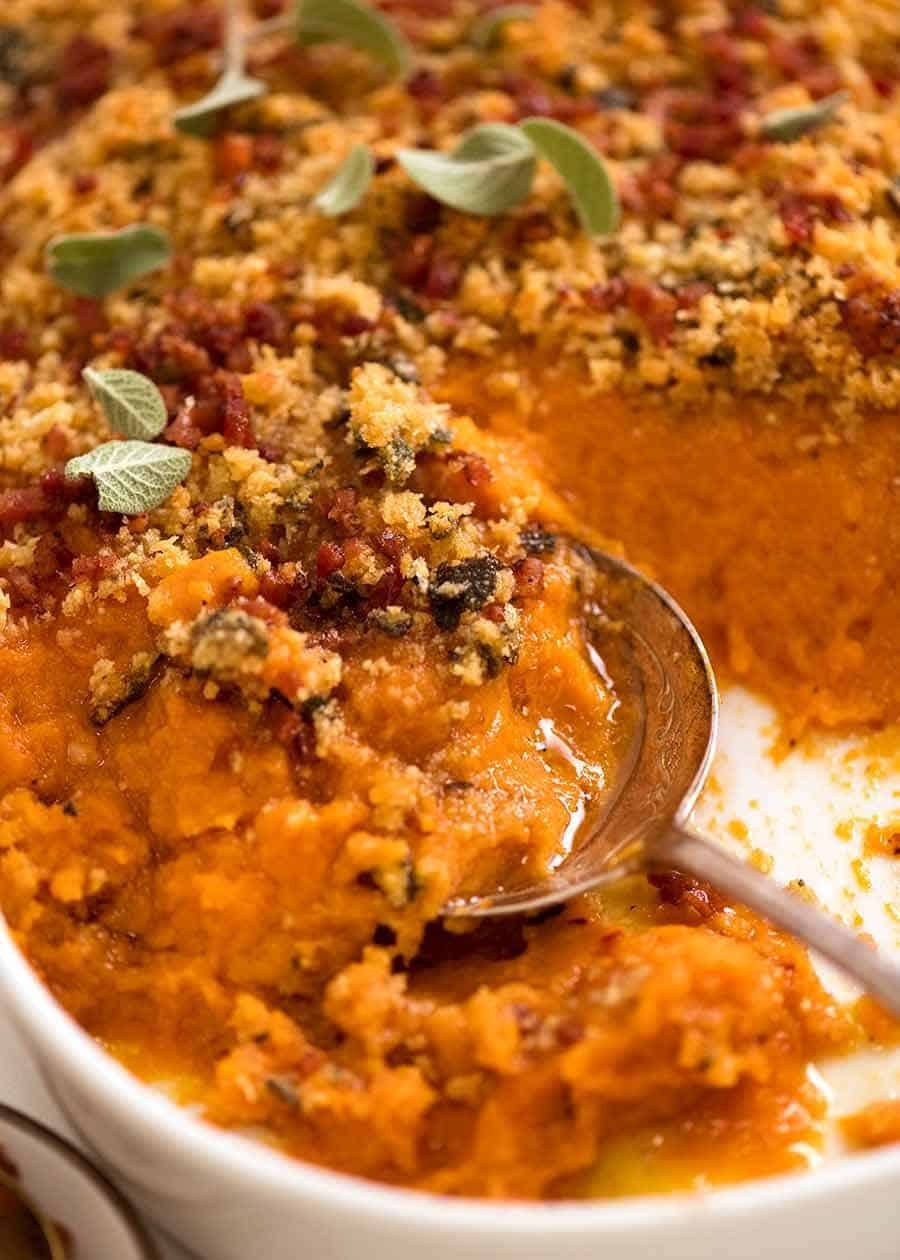 Close-up of golden brown creamy sweet potato casserole with melted butter topping