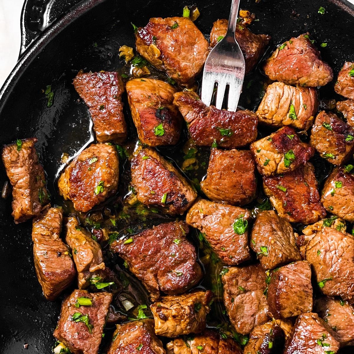 close up shot of garlic butter steak bites in a skillet