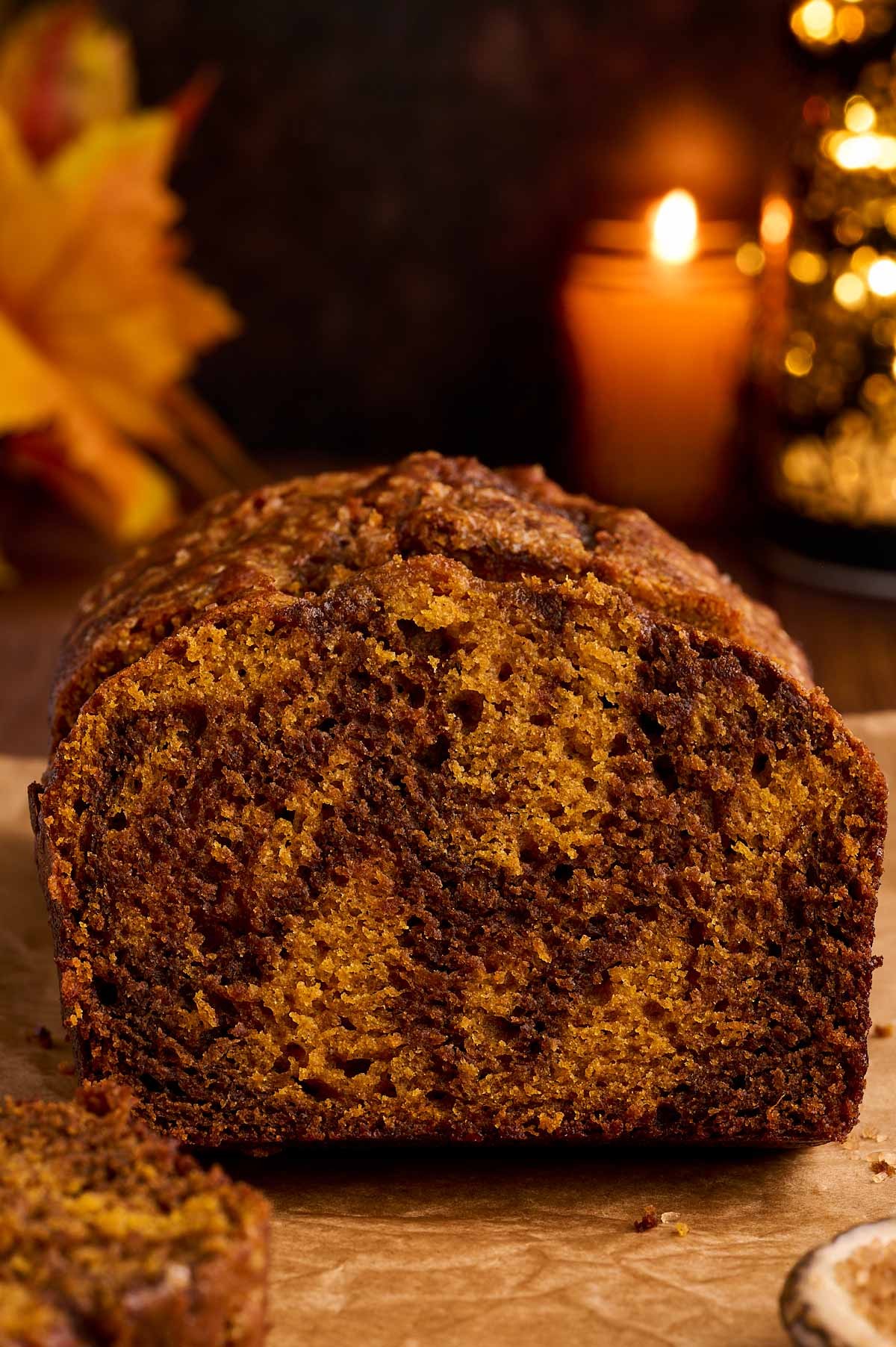 Pumpkin swirl bread loaf cooling on a wire rack with autumn leaves in background, natural lighting