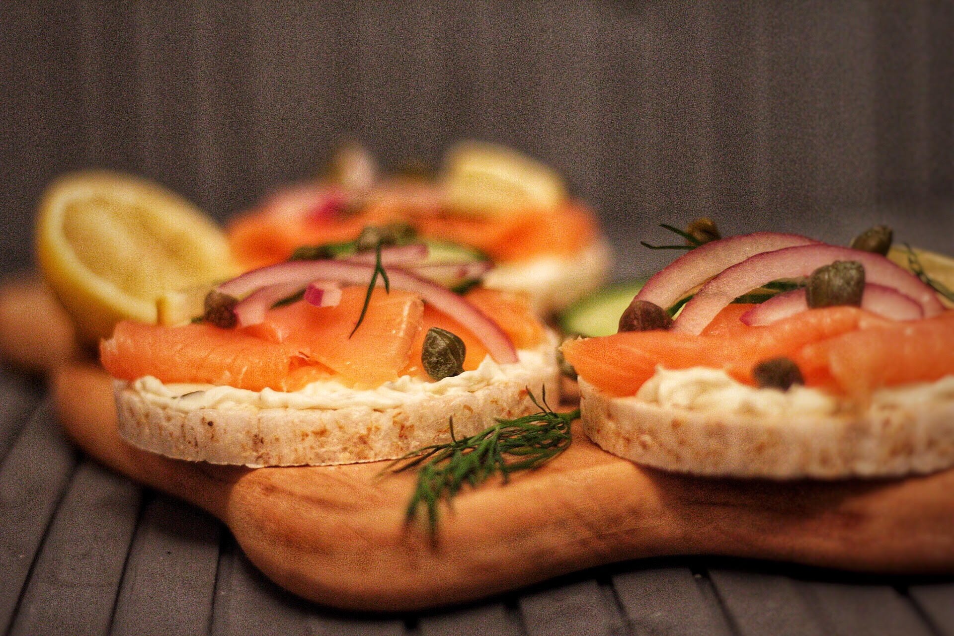 Savory rice cakes with smoked salmon, dill, and cream cheese, garnished with lemon