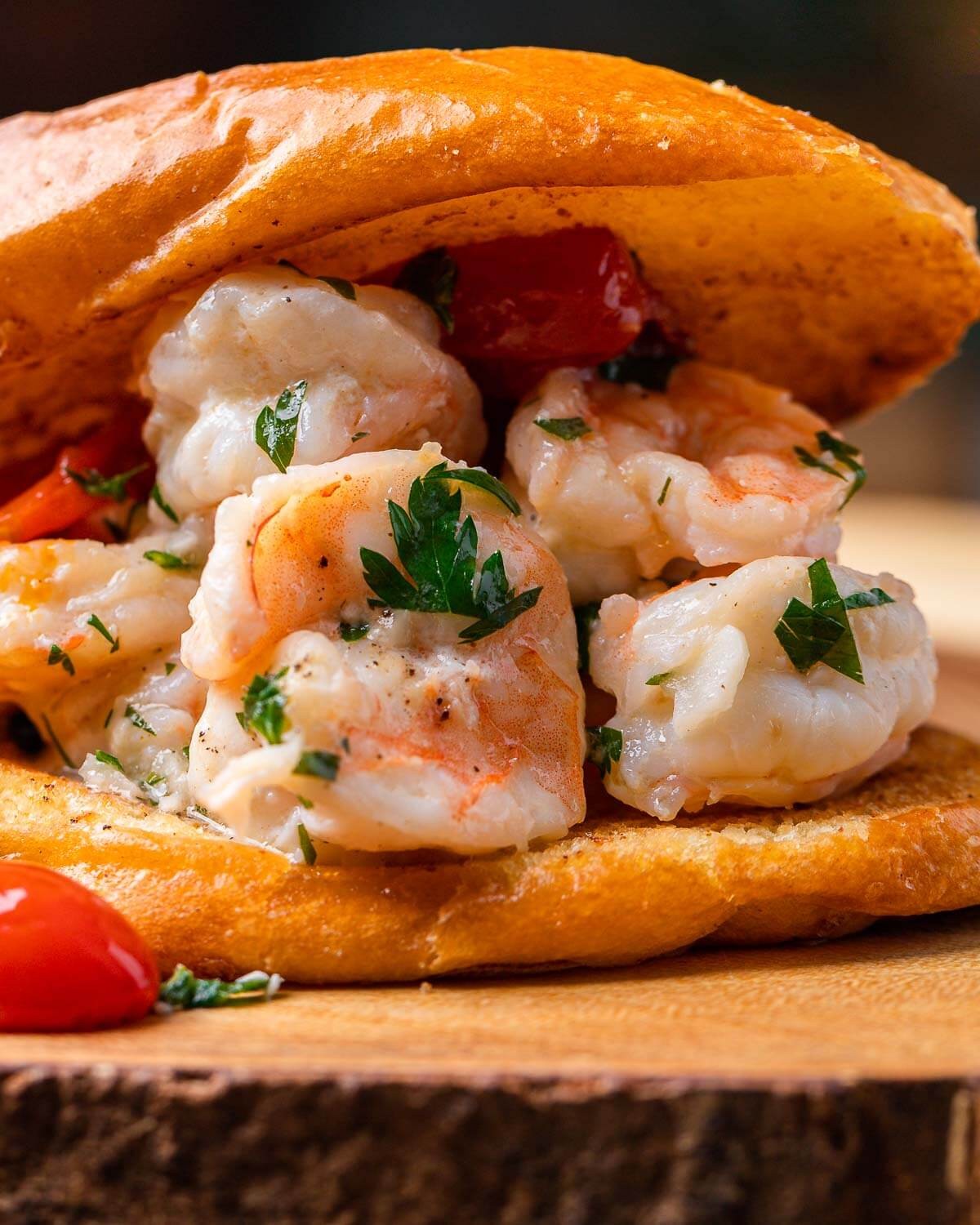 Close-up shot of delicious shrimp scampi sliders on a rustic wooden board