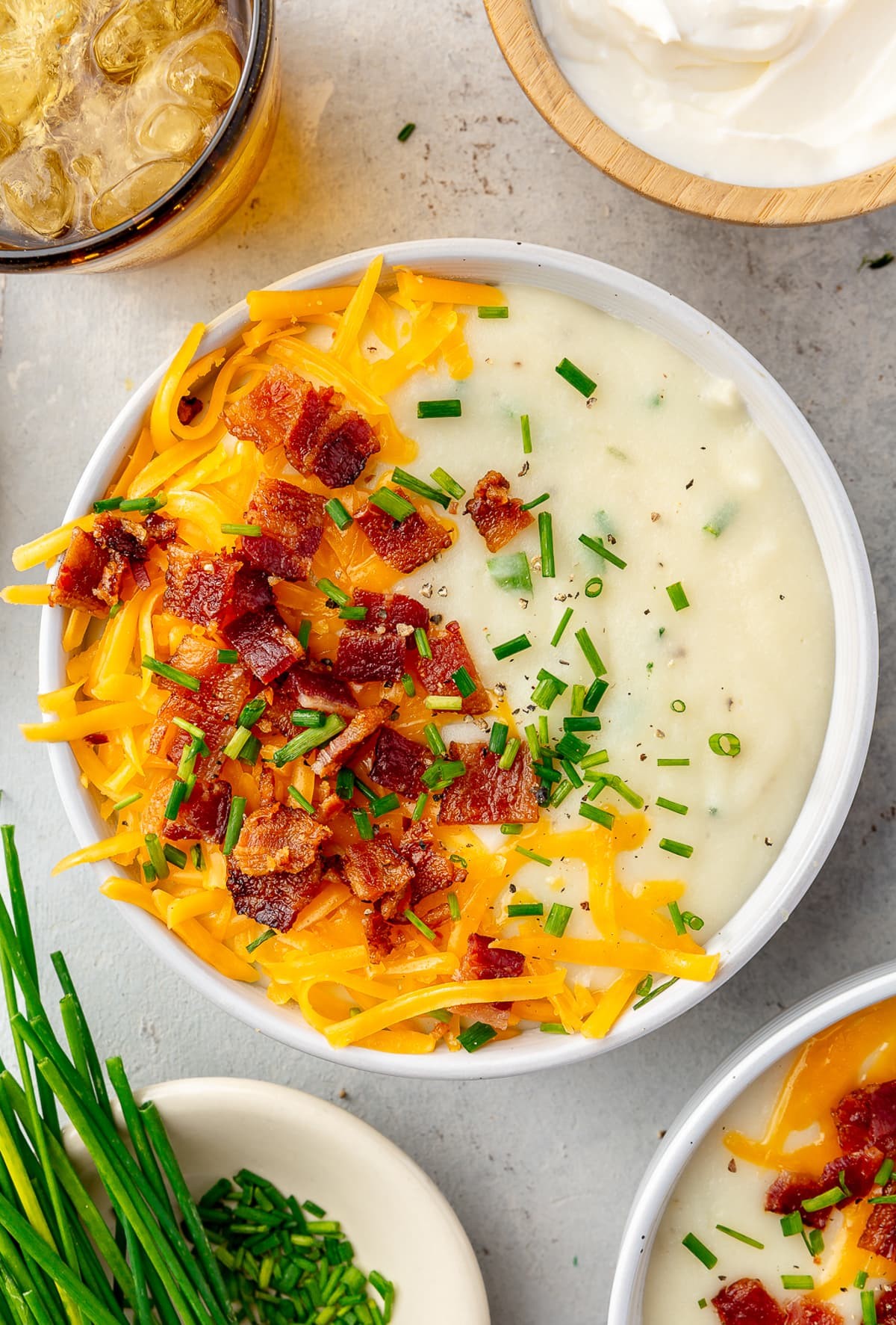 bowl of loaded baked potato soup with toppings