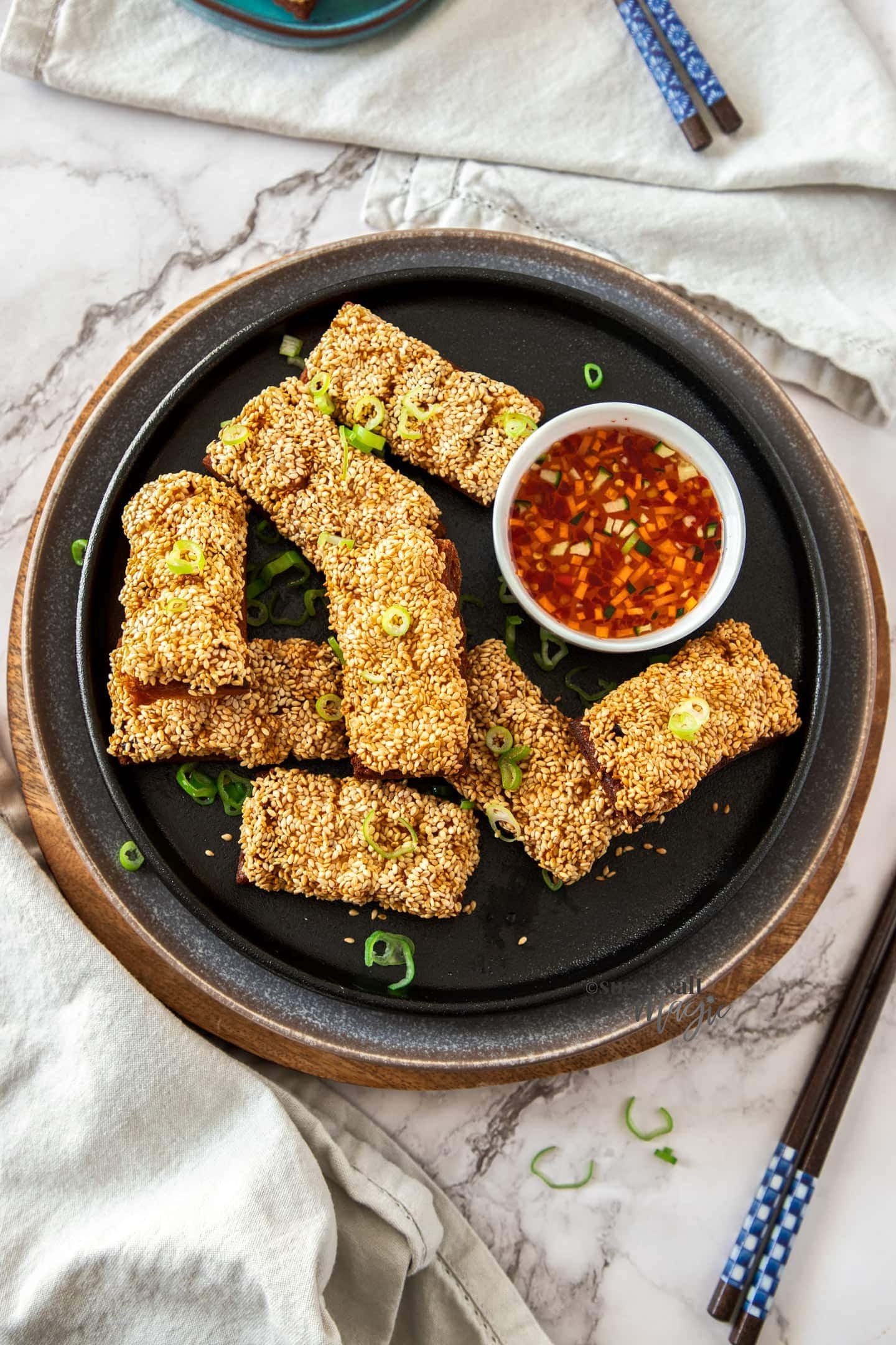 Crispy golden shrimp toast with sesame seeds, dipping sauce