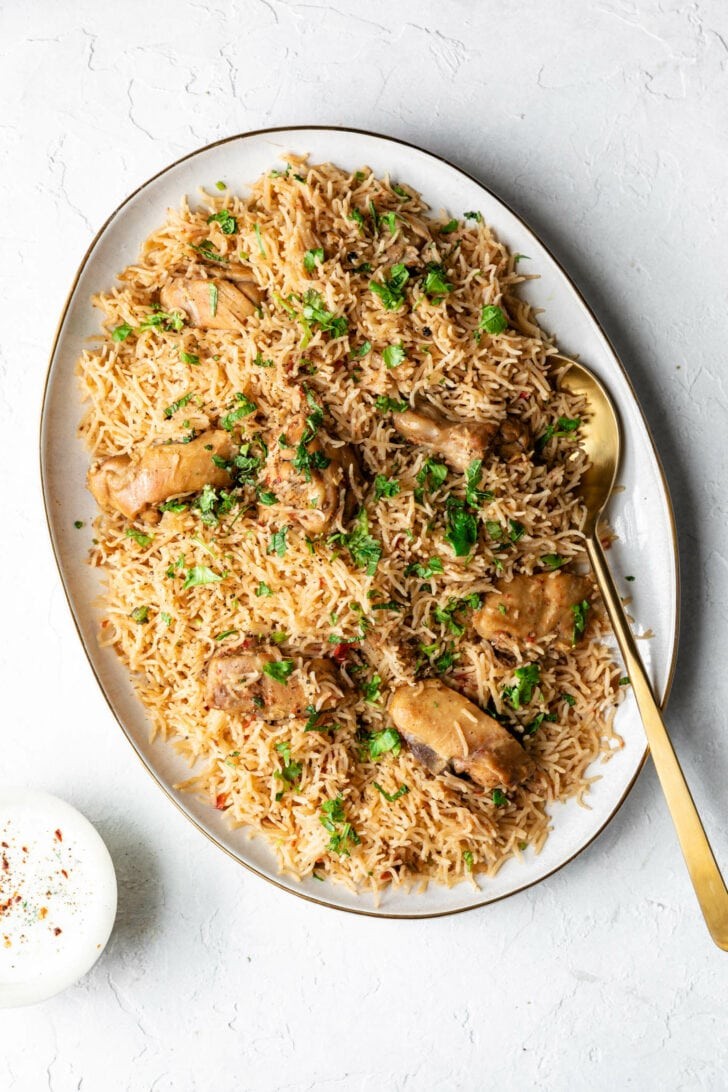 Aromatic butter chicken with fluffy pulao rice, garnished with cilantro