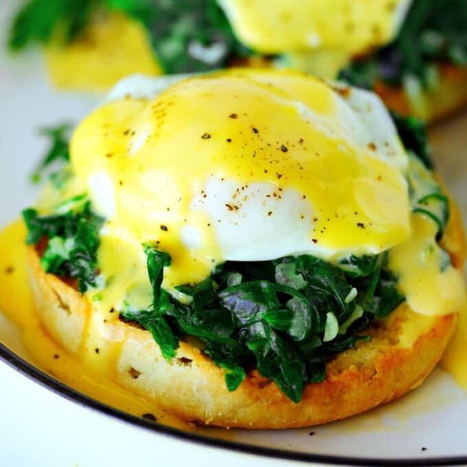 Close-up shot of an Eggs Florentine Wrap, showcasing the creamy eggs, vibrant spinach, and cheesy filling inside a warm tortilla