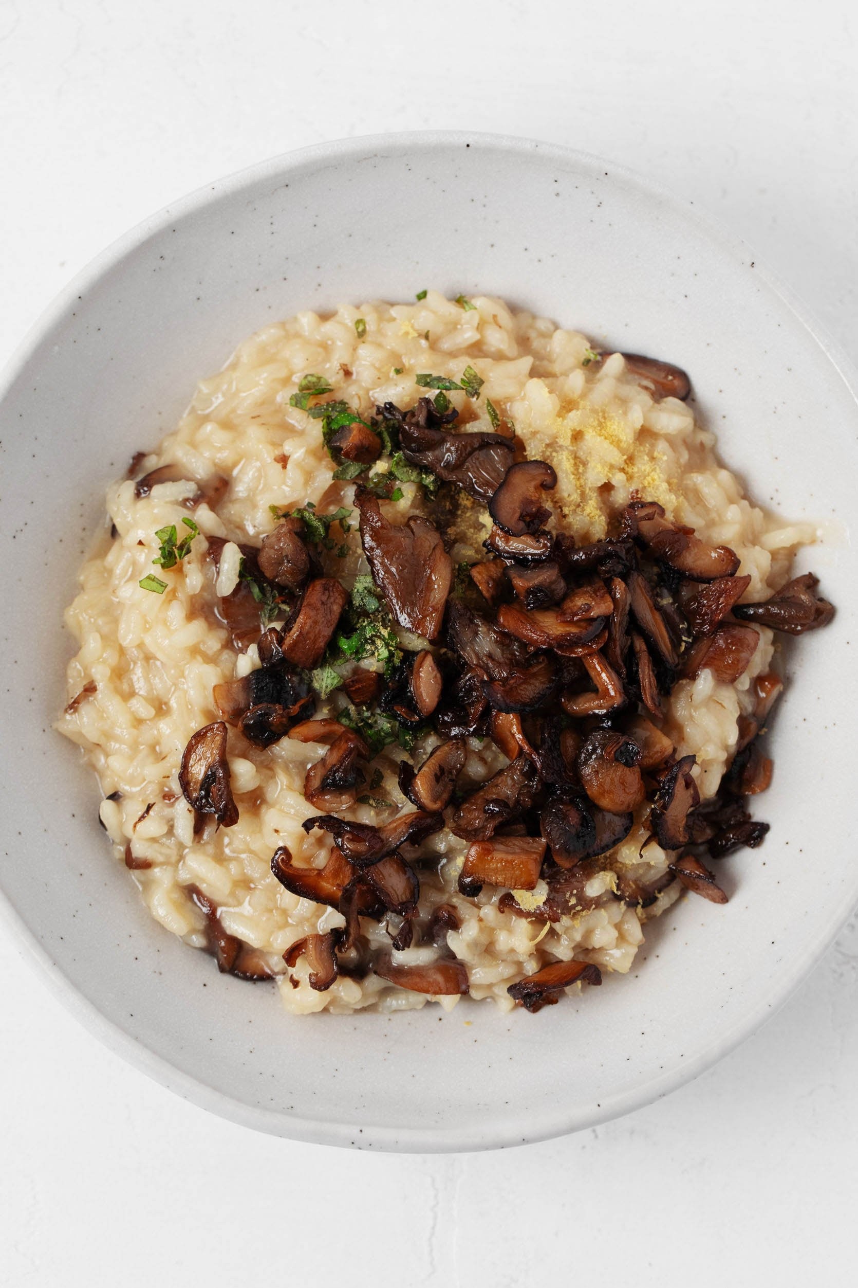 vegan fontina risotto being served in a bowl