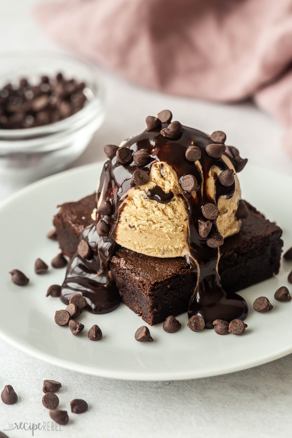 A decadent brownie sundae with a scoop of vanilla ice cream, chocolate sauce, and whipped cream