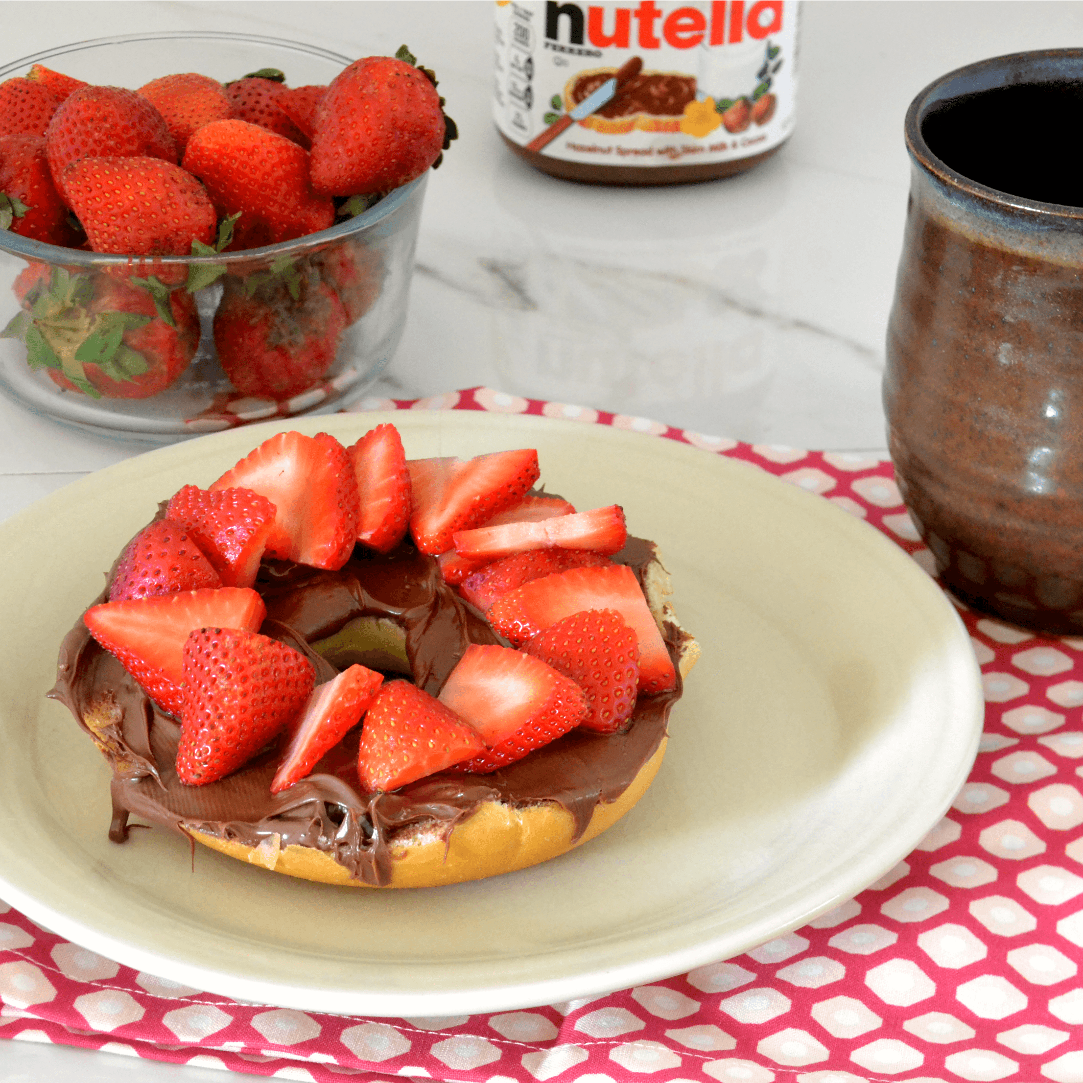 Close-up shot of mini bagels with Nutella and strawberries