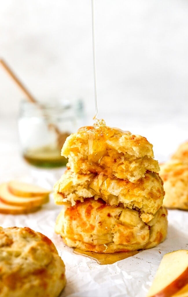apple cheddar biscuits with honey butter being served
