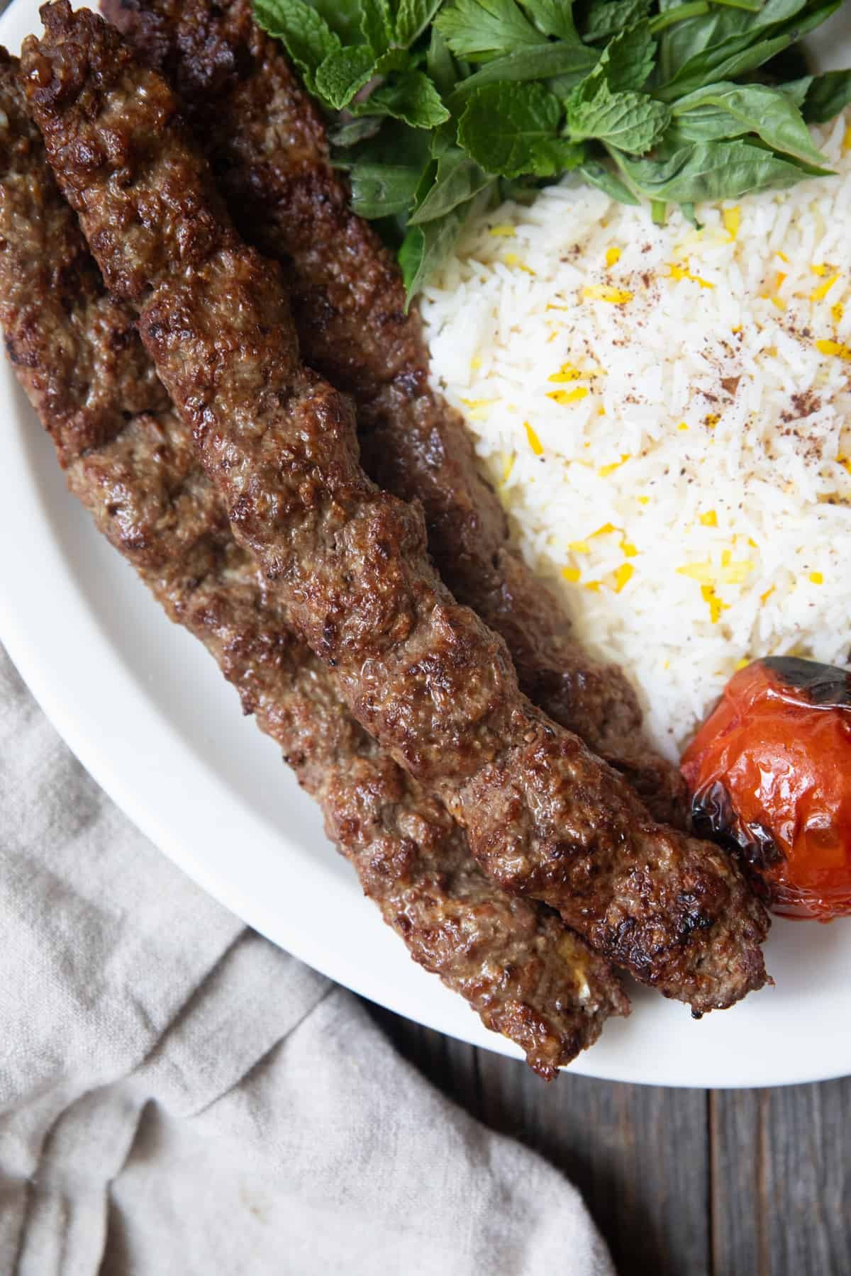 Iranian Koobideh Beef Kebabs on a grill, close-up shot