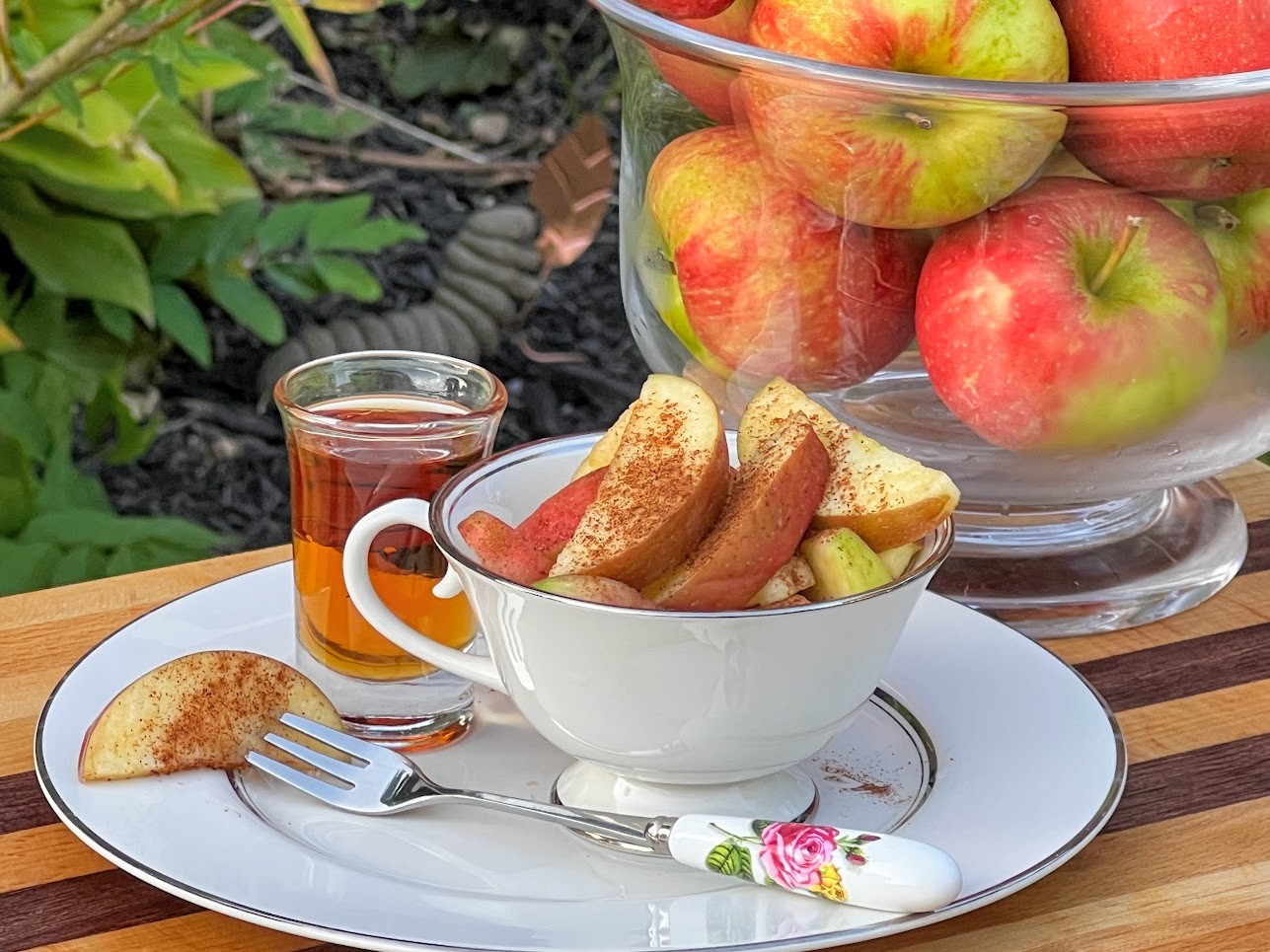 A vibrant and colorful Paleo Fruit & Cinnamon Bowl with sliced apples, cinnamon, and a drizzle of maple syrup