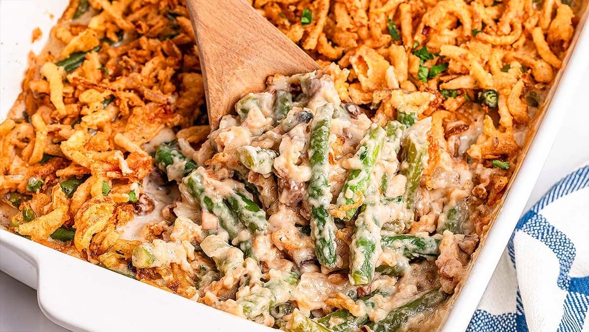 Classic green bean casserole with homemade gravy and crispy onions on a holiday table