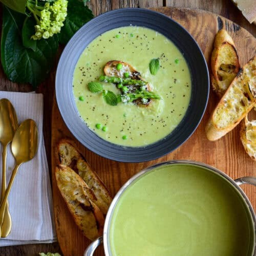 vibrant green asparagus and pea soup in a bowl