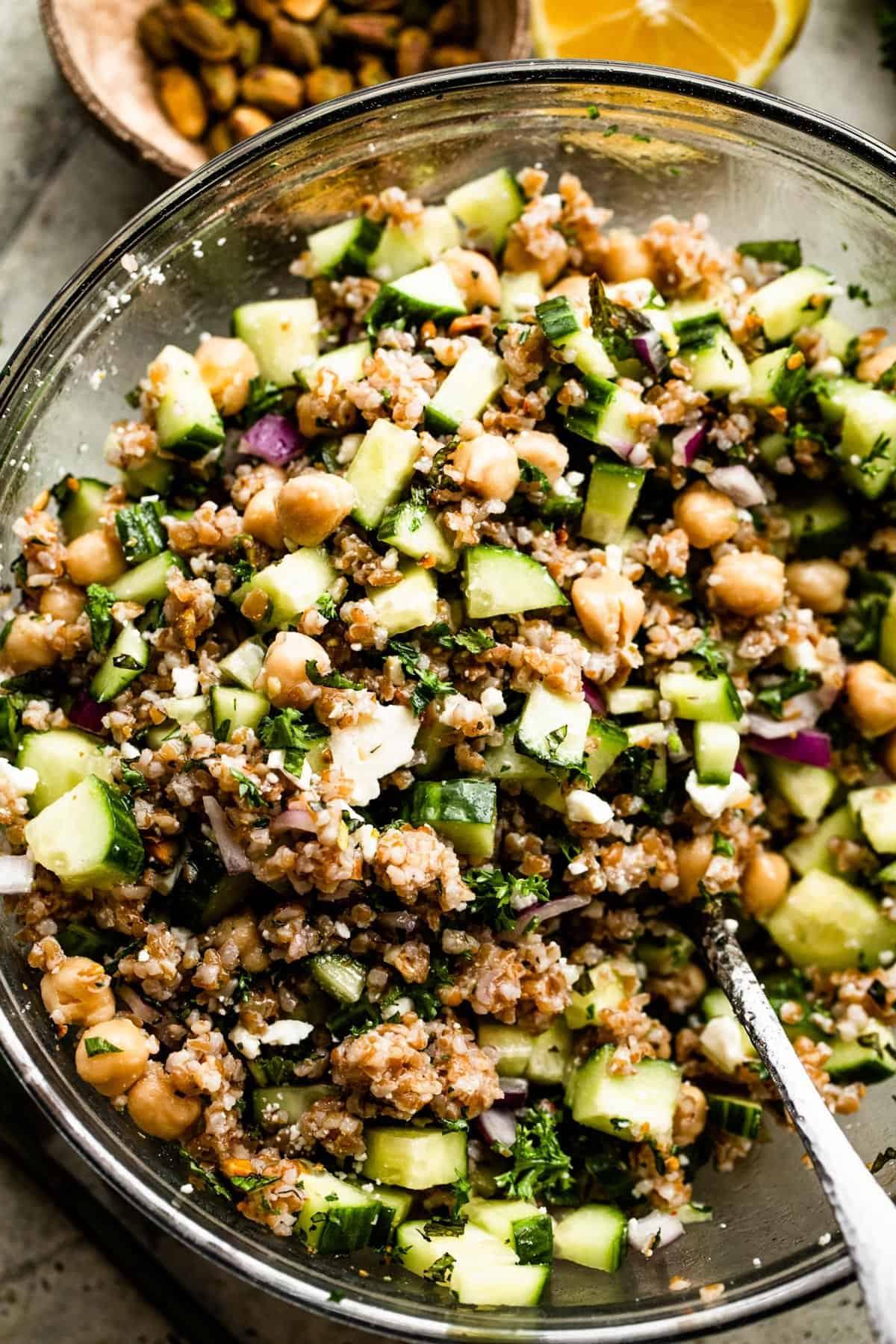 close-up shot of bulgur and chickpeas being mixed with herbs