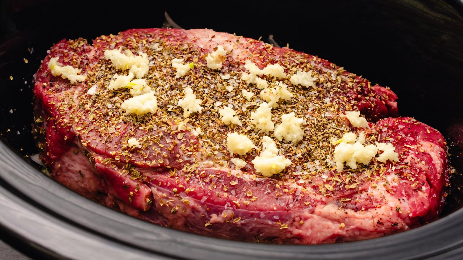 raw beef being prepared for slow roasting